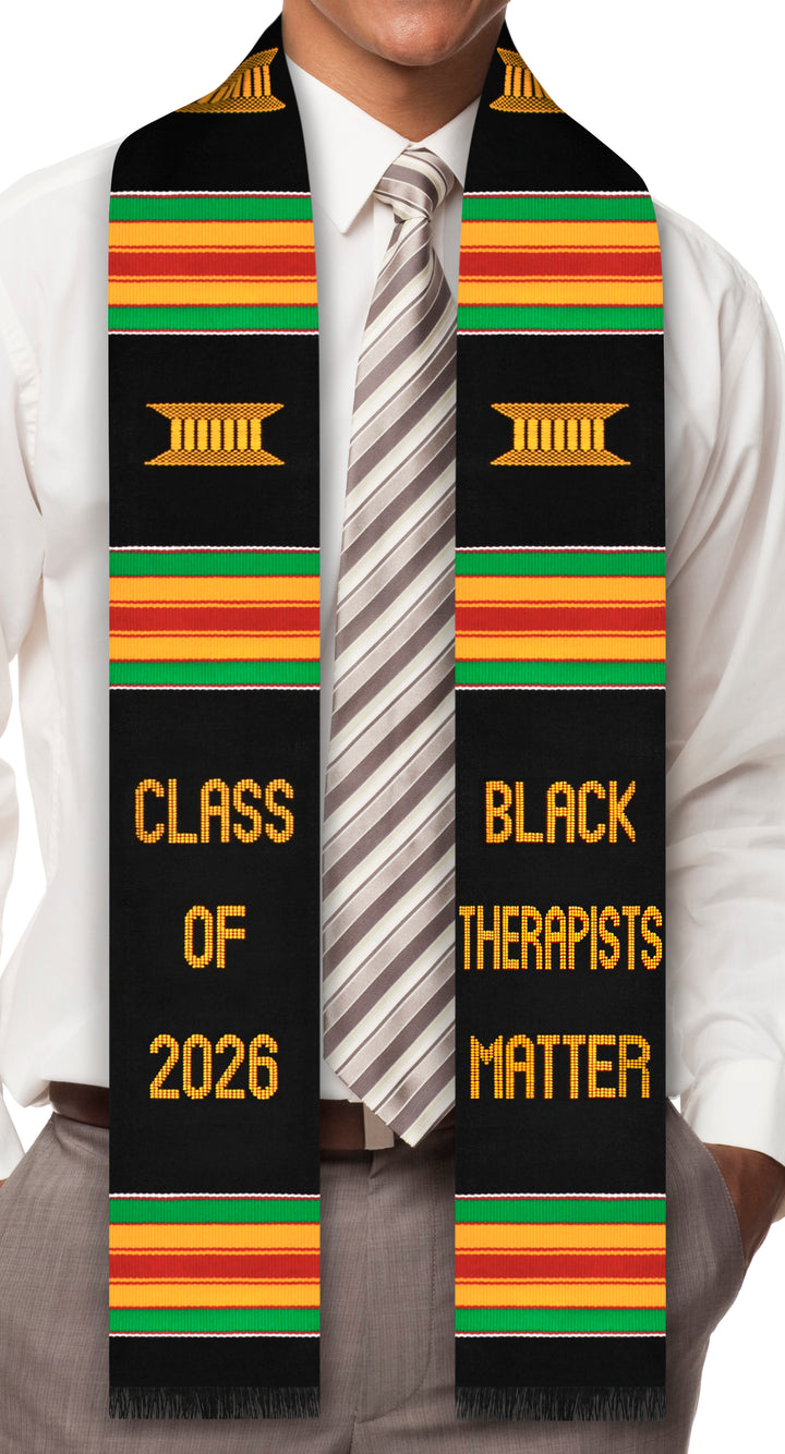 Graduation stole with 'Class of 2026' and 'Black Therapists Matter' text, worn by a person.